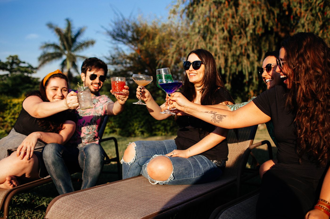 Friends raising glasses together outdoors